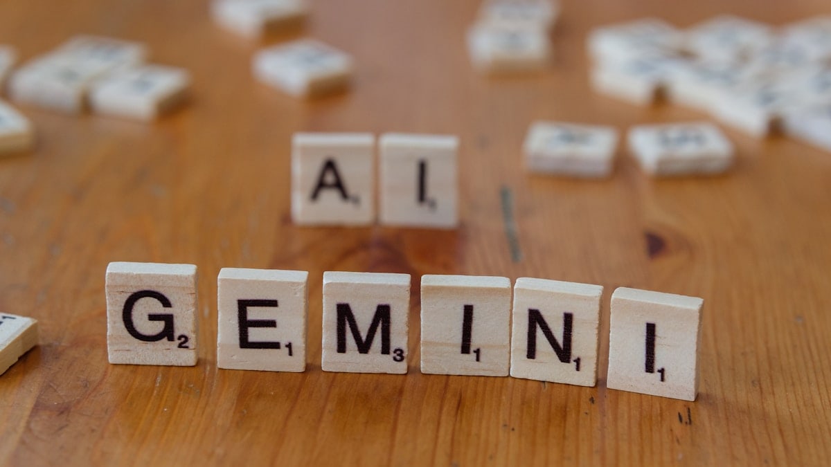 A wooden table topped with scrabble tiles that spell out the word all gen